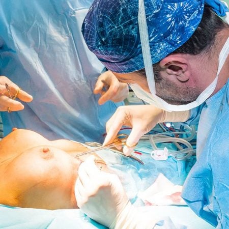 Surgeons perform breast reduction on a patient
