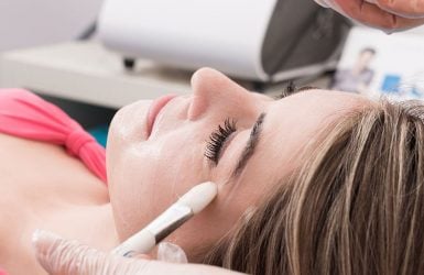 Woman receives chemical peel at spa