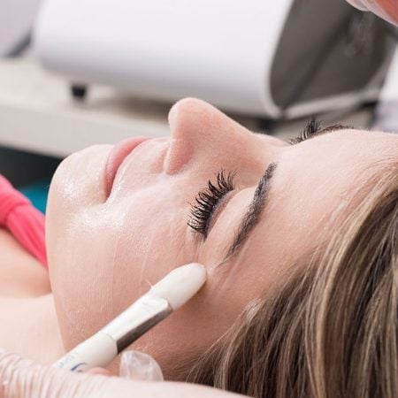Woman receives chemical peel at spa