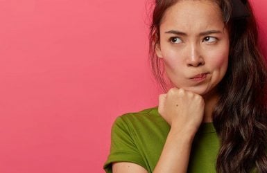 Woman with long dark hair in green shirt
