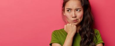 Woman with long dark hair in green shirt