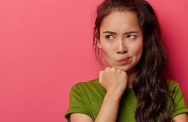 Woman with long dark hair in green shirt