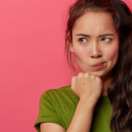 Woman with long dark hair in green shirt