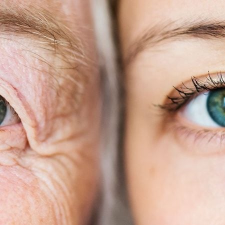 Two blue eyes: one older with wrinkles