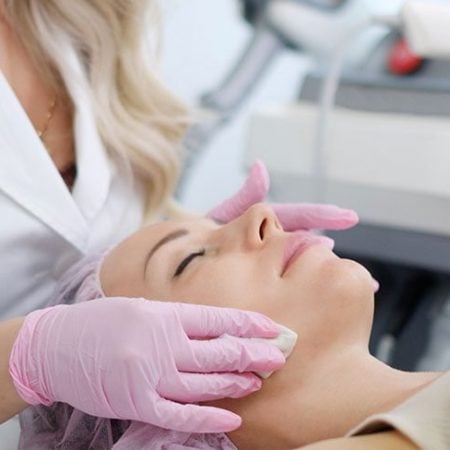 Woman gets laser facelift in clinic; eyes closed