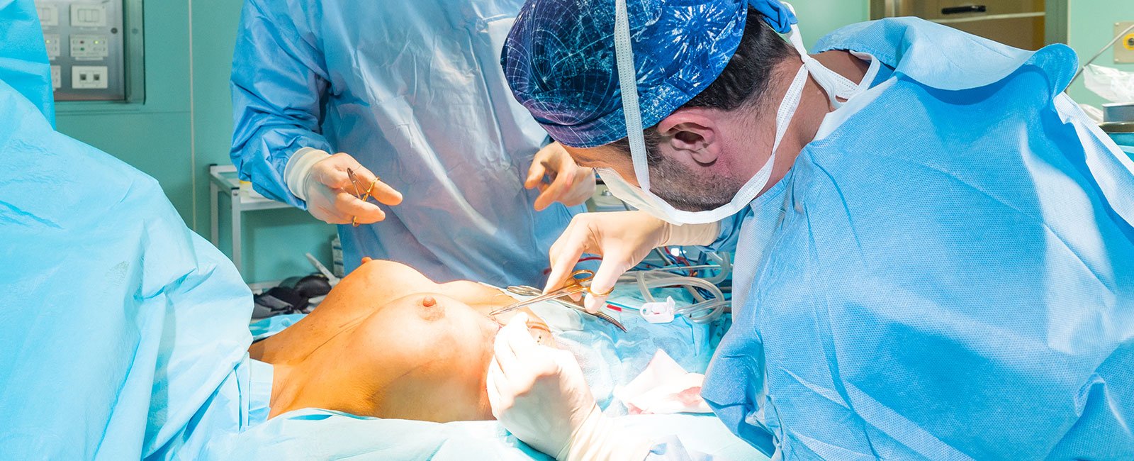 plastic-surgery-hawaii-hero-1 A surgeon performs a fat transfer breast procedure with assistance