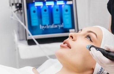 A person gets a HydraFacial with a device
