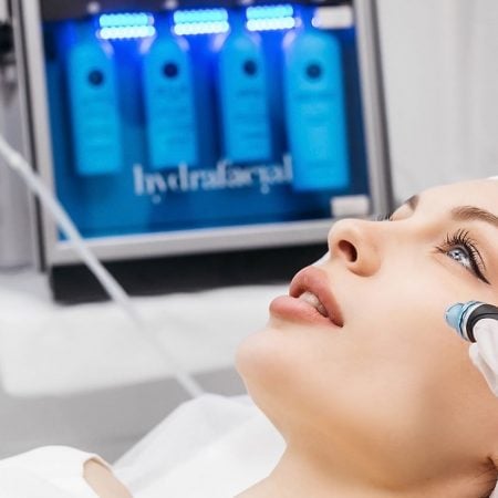 A person gets a HydraFacial with a device