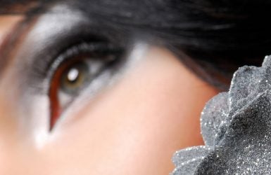 Close-up of a woman's eye with silver and black makeup