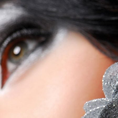 Close-up of a woman's eye with silver and black makeup