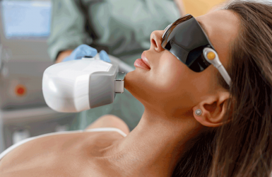 Woman gets facial laser treatment