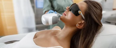 Woman gets facial laser treatment