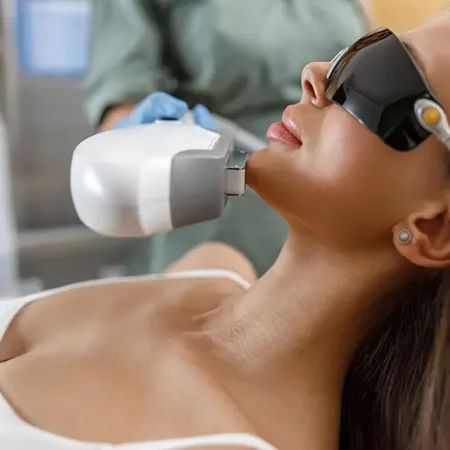 Woman gets facial laser treatment
