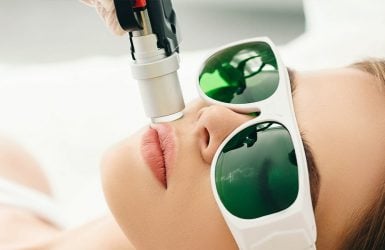 Laser hair removal on upper lip; person wears goggles